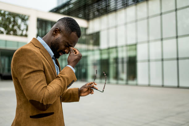 istock Tired black businessman having eyesight problems outdoors. 2205777213