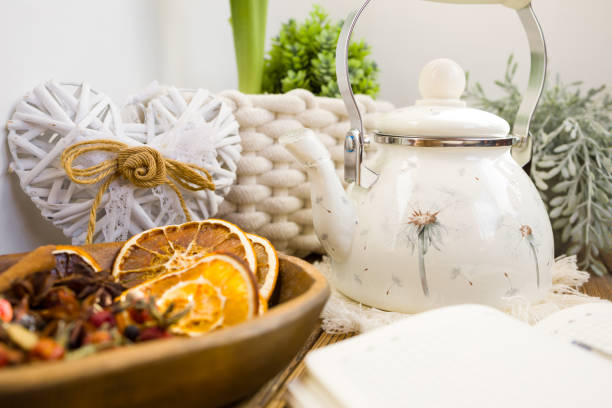 istock Enameled teapot with gooseberries, cranberries and cinnamon sticks. Spicy aromatic tea 2205777730