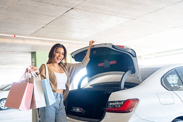 istock Asian woman keep shopping bag in car trunk. 2205779846