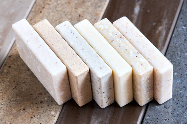 istock Porcelain stoneware artificial stone square samples as kitchen countertop examples of future kitchen fasade exterior. Samples slabs of natural granite marble quartz for stone countertops close up. 2205789710