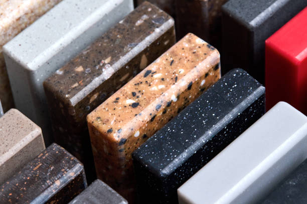 istock Porcelain stoneware artificial stone square samples as kitchen countertop examples of future kitchen fasade exterior. Samples slabs of natural granite marble quartz for stone countertops close up. 2205789714