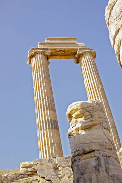 The Temple of Apollo is a Roman temple built around 150 A.D. during the Pax Romana era in the ancient Carian town of Side, in southern Turkey on the Mediterranean Sea coast and dedicated to Apollo, the Greek and Roman god of music, harmony and lightAn impressive artifact of Roman architecture, this image showcases three delicately crafted ancient columns from an archaeological site in Turkey, symbolizing history, culture, and artistic triumphs over time.