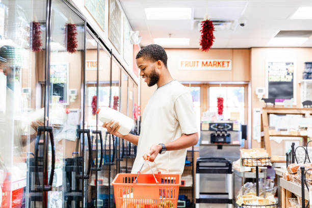 istock Man Selecting Milk at a Local Grocery Store 2205791341