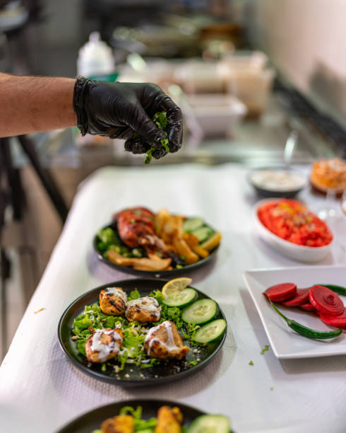 istock Chef adding parsley to delicious indian food in a restaurant kitchen 2205794662