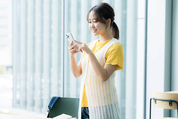istock Young woman operating a smartphone 2205796202