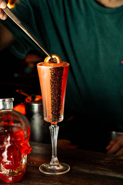istock Halloween Mixology: Red Cocktail in Skull Bottle 2205801077