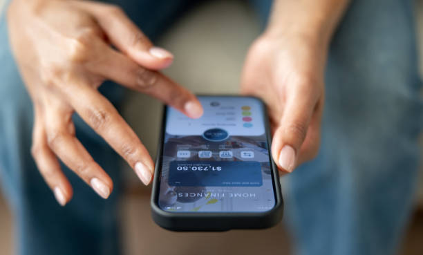 istock Woman organizing her home finances using a mobile app on her cell phone 2205801167