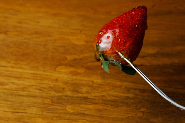 Chocolate Covered Strawberry With Reflection Against Black Background