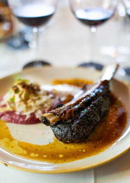 istock Beef Rib with Red Wine Glasses in Background 2205802928
