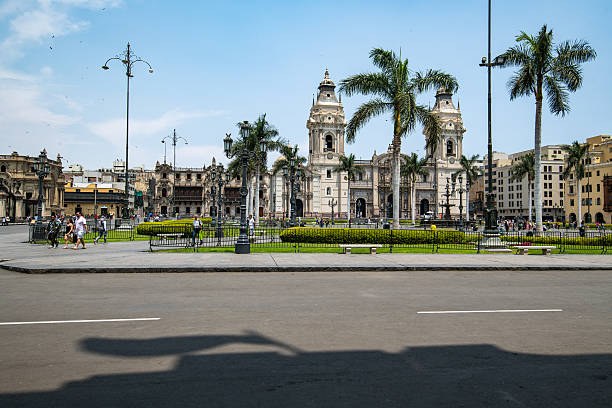 Plaza Mayor de Lima with a view of palm trees and the Lima Cahtedral in the background on a clear sunny day in centro historico, Lima, peru stock photo