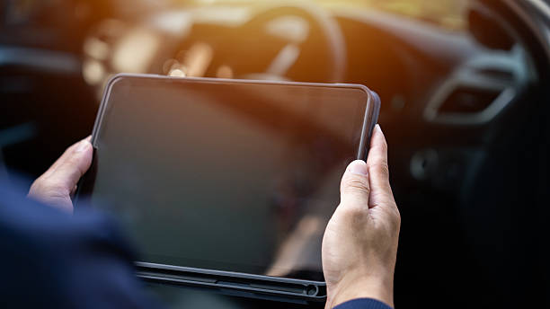 istock A person is holding a tablet in their hand, possibly using it to navigate a car. Concept of technology and modernity, as well as the idea of being in control of a vehicle 2205809930