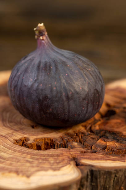 istock ripe purple figs on a juniper board 2205812081