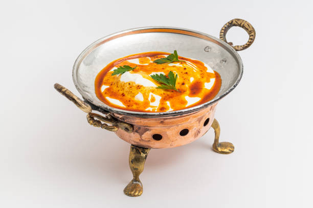 Poached egg Turkish name Cilbir, a classic Turkish dish, on a metal plate