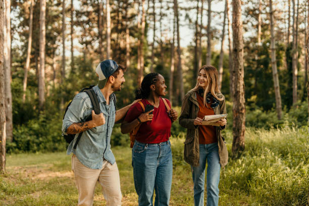 istock Hikers walking and talking in the forest 2205814291