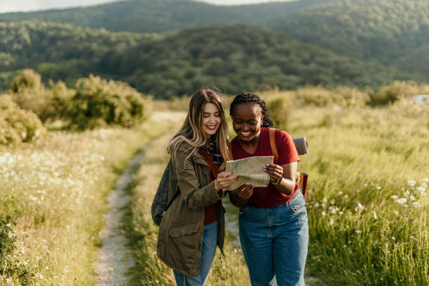 istock Two women hikers using map and smartphone in forest 2205814520