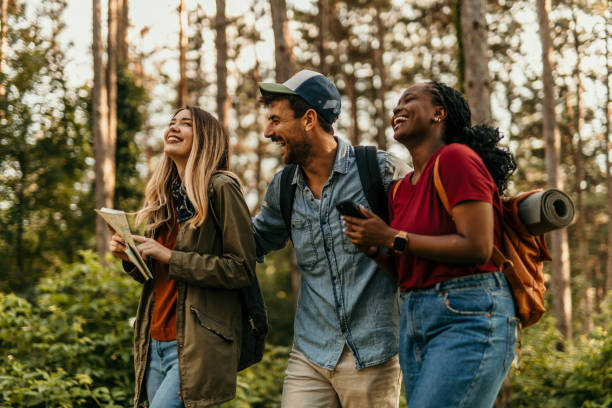 istock Friends using a smartphone and exploring nature in the forest 2205814563
