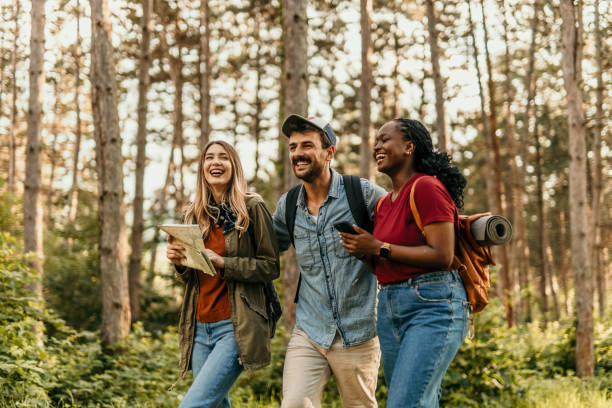 istock Friends using a smartphone and exploring nature in the forest 2205814585