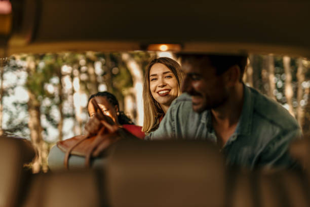 istock Happy friends laughing while unpacking their car during a camping trip 2205815156