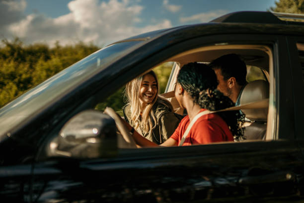 People laughing and talking during a car trip