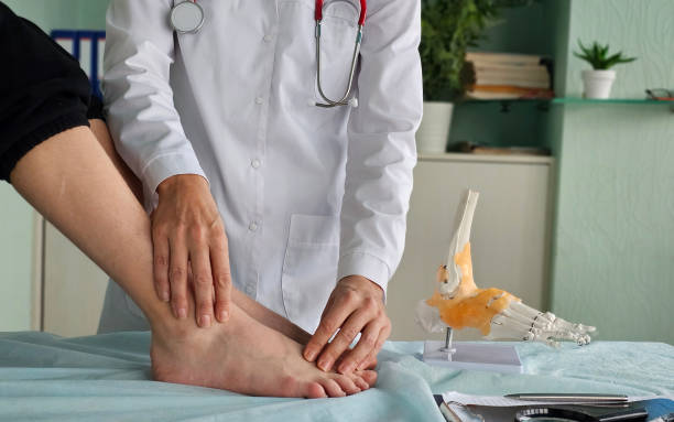 istock Doctor performing ankle examination on patient 2205815309