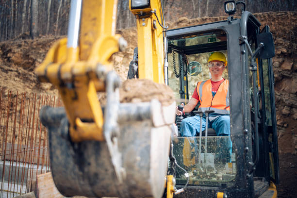 istock Cheerful excavator driver digging trench at construction site. 2205816807