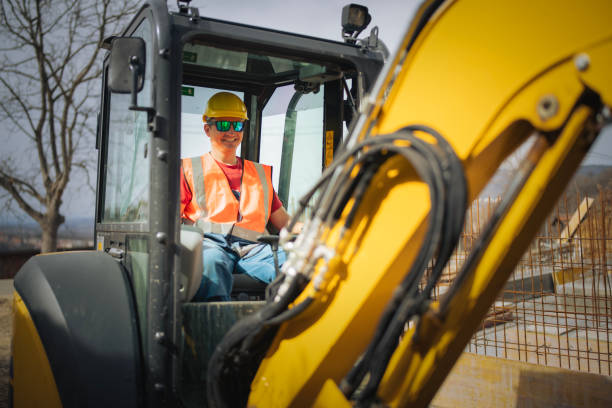 istock Male excavator driver working at a construction site. 2205816813