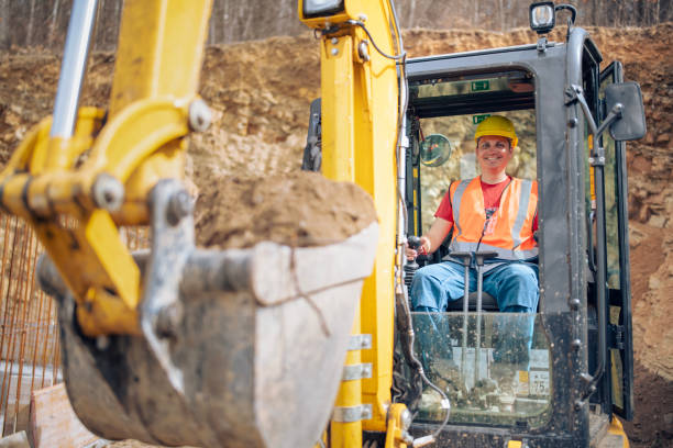 istock Cheerful excavator driver digging trench at construction site. 2205816819
