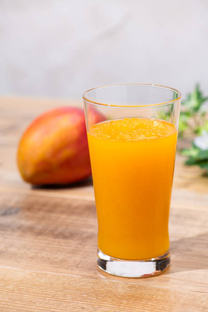 istock Mango and mango frappe on a wooden table 2205818214