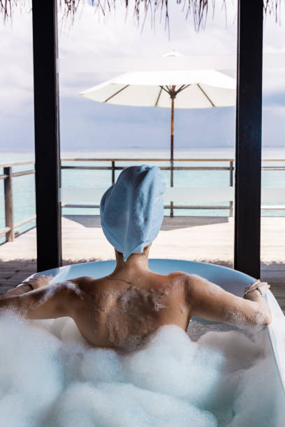 istock Back view of a woman having bubble bath. 2205818718