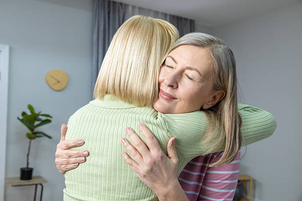 istock Two women hugging each other and feeling happy 2205818884