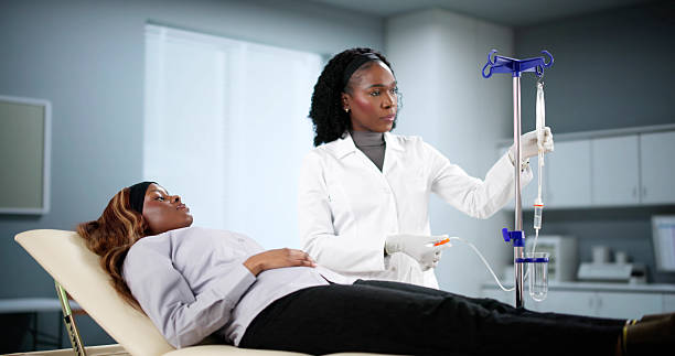 istock Medical Professional Administers Vitamin Drip Therapy 2205819303