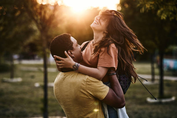 istock Young happy couple having fun in nature at sunset. 2205820415