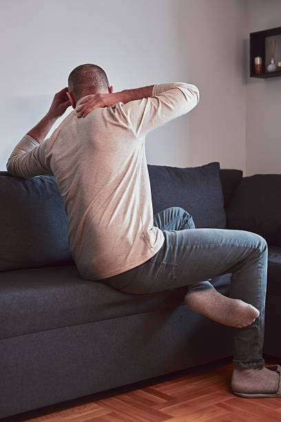 istock Man with neck pain at home. 2205820468