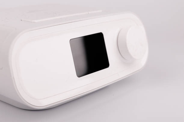 istock Professional CPAP machine for breathing assistance with digital display, hose, and face mask 2205822856