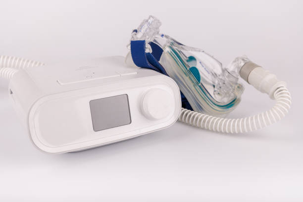 istock A modern CPAP machine with a digital screen, flexible hose, and ergonomic mask for sleep apnea therapy, placed on a clean white background 2205824043