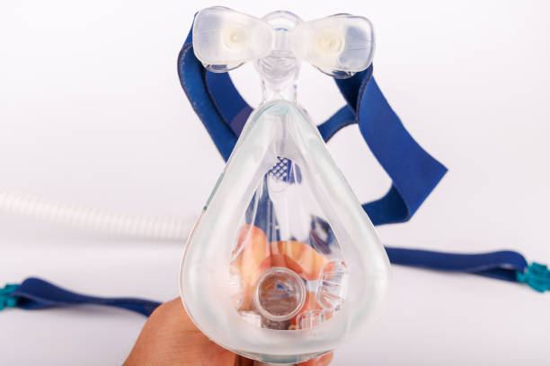 A professional-grade CPAP device with an attached face mask, long breathing hose, and medical display, designed for sleep therapy