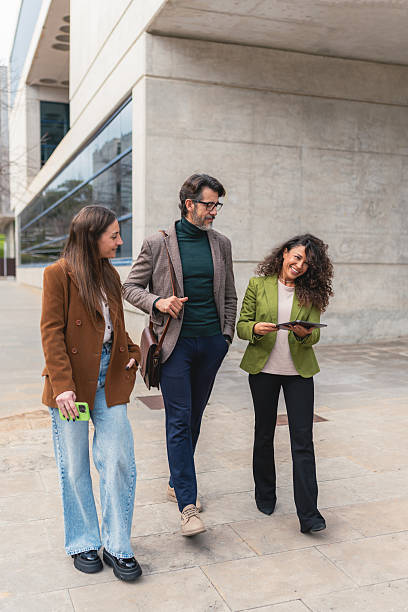 istock Smiling Business Team Walking and Collaborating with Tablet 2205824363