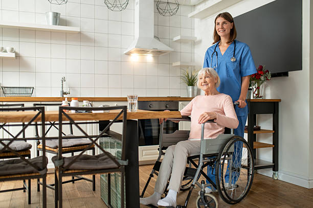istock Care assistant and her patient looking contented and smiling 2205824762