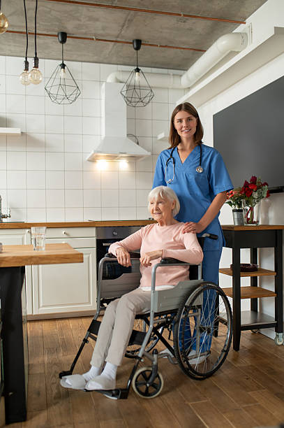 istock Care assistant and her patient looking contented and smiling 2205824770