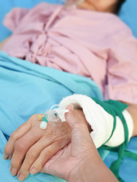 istock holding hand of senior patient with saline solution preparation 2205825158