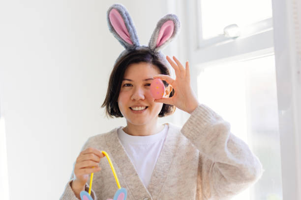 istock Happy young woman is holding Easter eggs 2205825213
