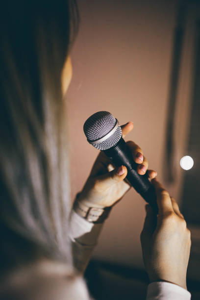 istock The woman holding microphone and singing. 2205825802