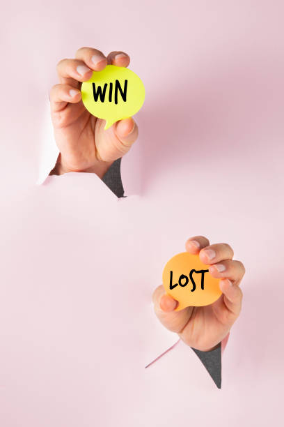 istock Win and Lost Choices Holding by Hands 2205826146