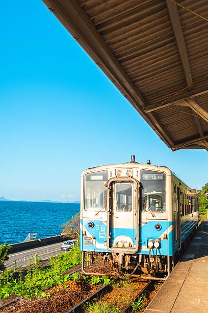 istock Blue train at seaside station with ocean view. 2205827292