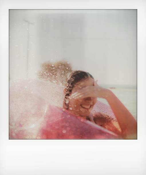 rear view of woman dancing, feeling carefree and enjoying foam party.