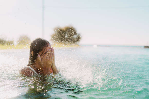 Young woman trending water in a lake