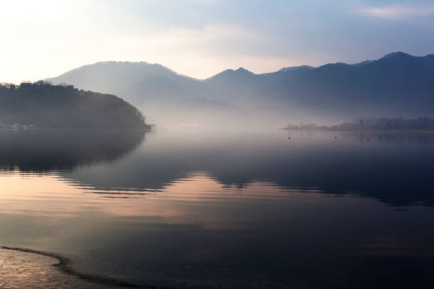 The mountains and the afterglow of the sun are reflected in the lake