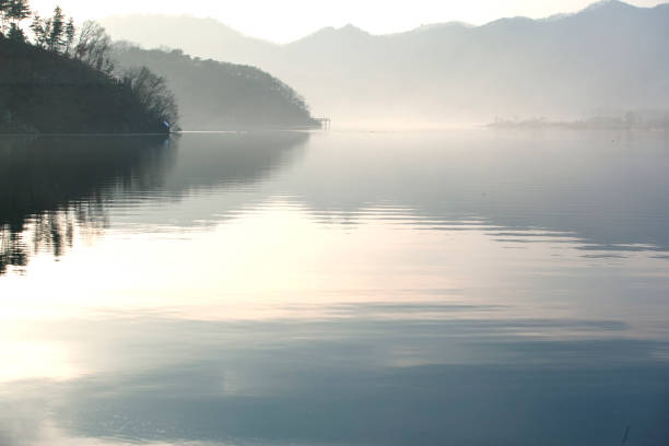 istock foggy lake and reflection in late afternoon 2205830519