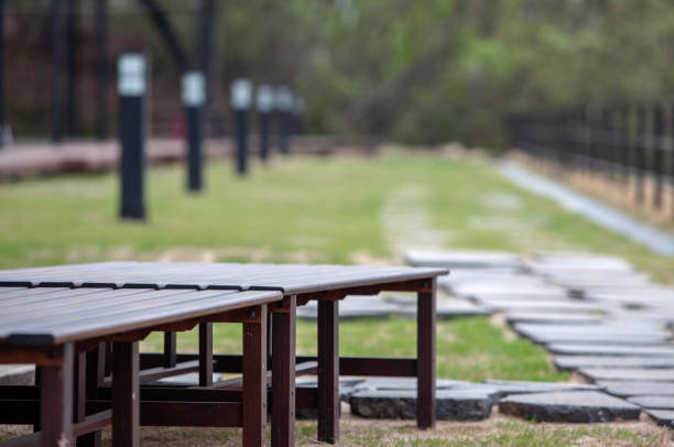An inviting outdoor lounge area features two comfortable sofas with light cushions and a rustic dark wooden table
