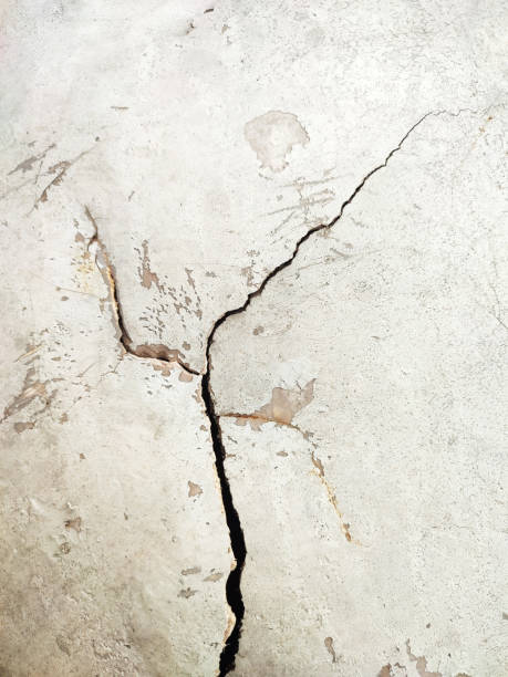 istock close up of white cracked wall 2205833687
